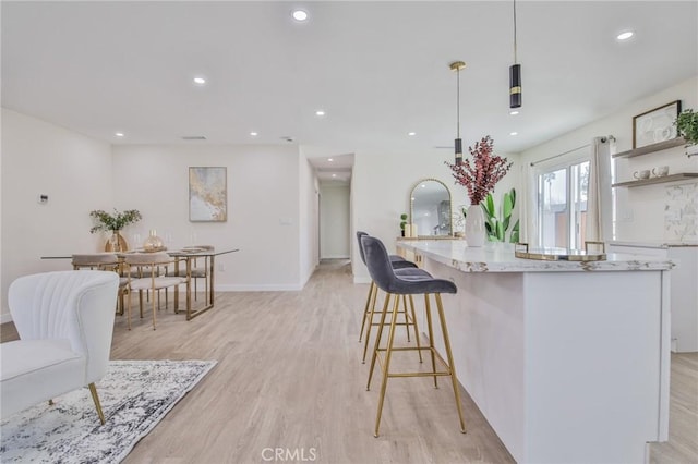 kitchen with recessed lighting, hanging light fixtures, light wood-style flooring, and open shelves