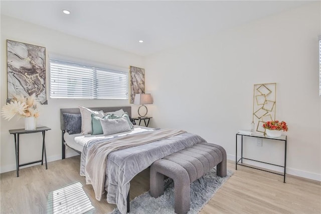 bedroom with light wood finished floors, recessed lighting, and baseboards