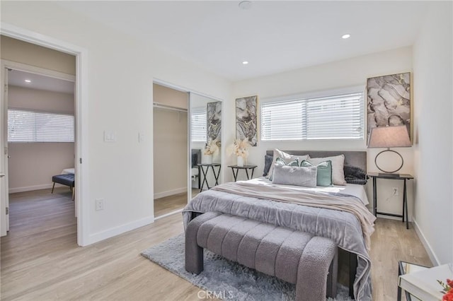 bedroom with light wood-type flooring, baseboards, and recessed lighting