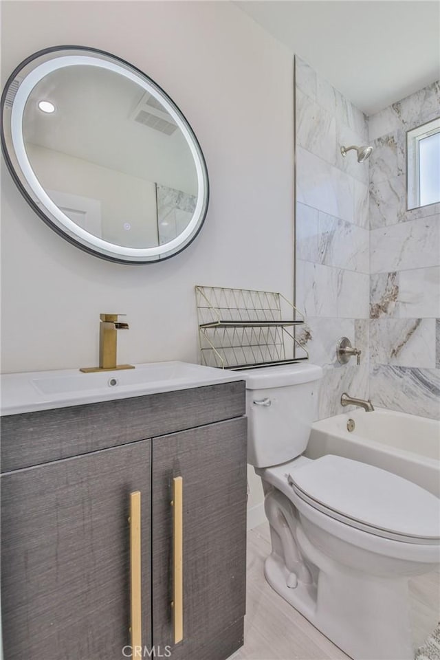 bathroom with toilet, bathtub / shower combination, and vanity