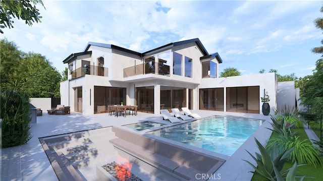 rear view of house featuring an infinity pool, an outdoor fire pit, a patio, and stucco siding