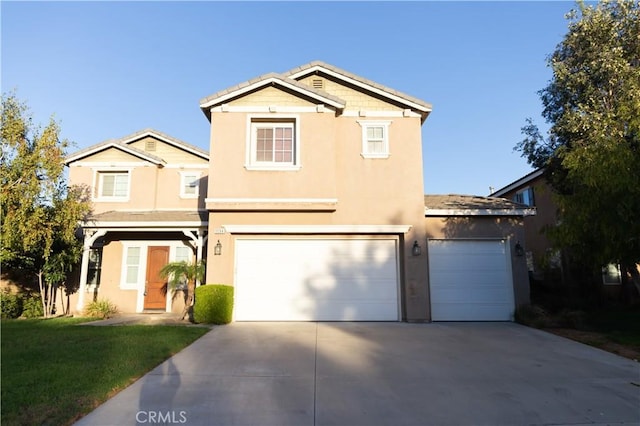 traditional-style house with driveway, a front yard, and stucco siding