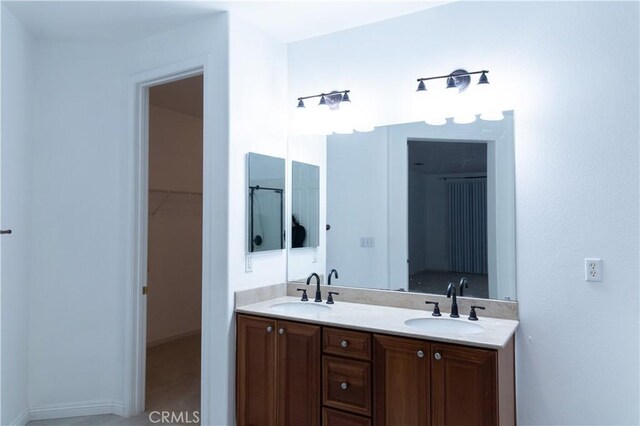 1594 Margit St, Redlands, CA 92374 - bathroom with a walk in closet, double vanity, and a sink