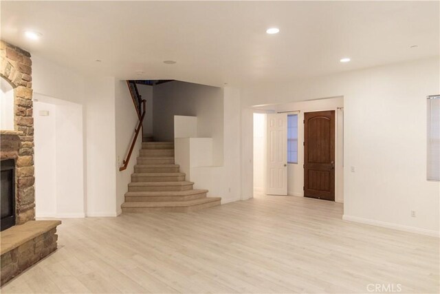 1594 Margit St, Redlands, CA 92374 - unfurnished living room featuring recessed lighting, light wood-style floors, a stone fireplace, baseboards, and stairway