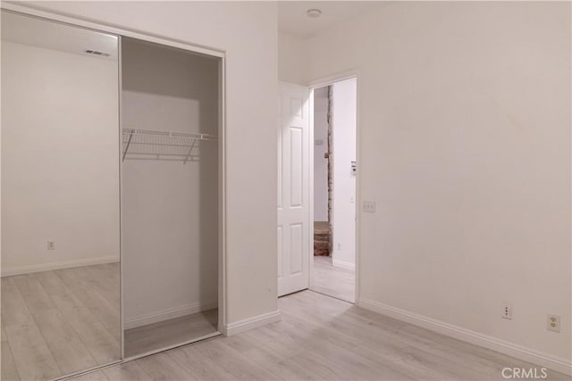 1594 Margit St, Redlands, CA 92374 - unfurnished bedroom featuring light wood finished floors, a closet, visible vents, and baseboards