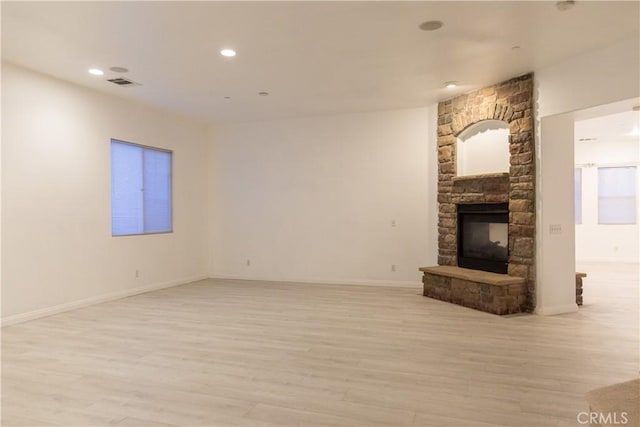 1594 Margit St, Redlands, CA 92374 - unfurnished living room featuring light wood finished floors, recessed lighting, visible vents, and a stone fireplace