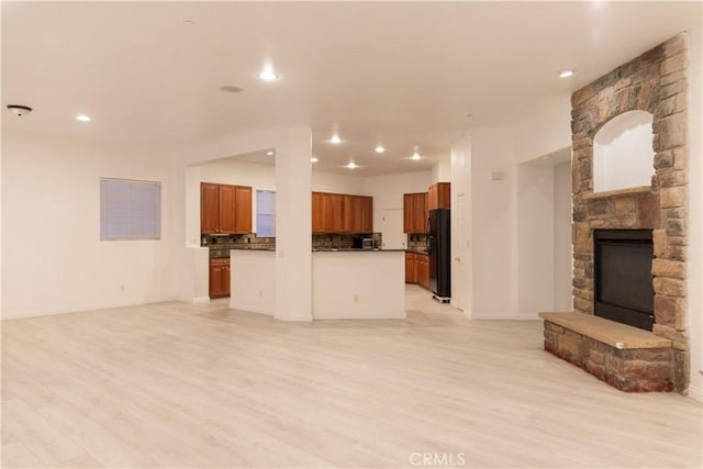 1594 Margit St, Redlands, CA 92374 - unfurnished living room with recessed lighting, a stone fireplace, baseboards, and light wood-style floors