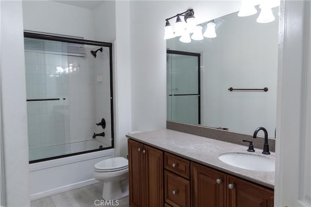 1594 Margit St, Redlands, CA 92374 - bathroom featuring toilet, bath / shower combo with glass door, wood finished floors, and vanity