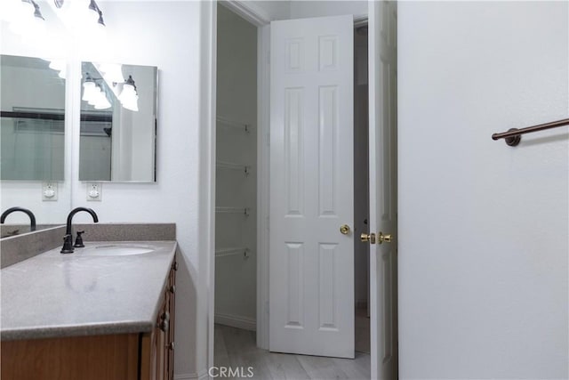 1594 Margit St, Redlands, CA 92374 - bathroom featuring wood finished floors, vanity, and baseboards
