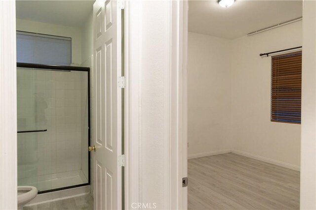 1594 Margit St, Redlands, CA 92374 - full bathroom with toilet, a stall shower, wood finished floors, and baseboards