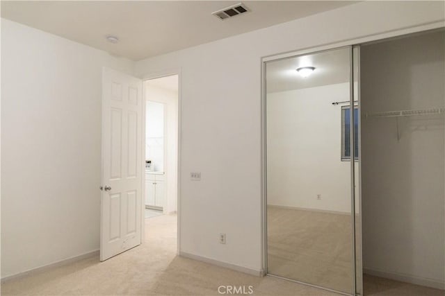1594 Margit St, Redlands, CA 92374 - unfurnished bedroom featuring light colored carpet, visible vents, baseboards, and a closet