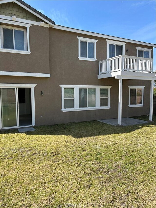 1594 Margit St, Redlands, CA 92374 - back of property with a patio, a lawn, stucco siding, and a balcony