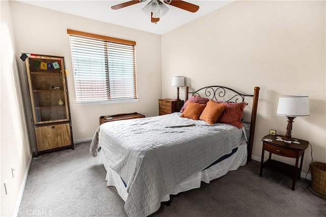 carpeted bedroom with ceiling fan and baseboards