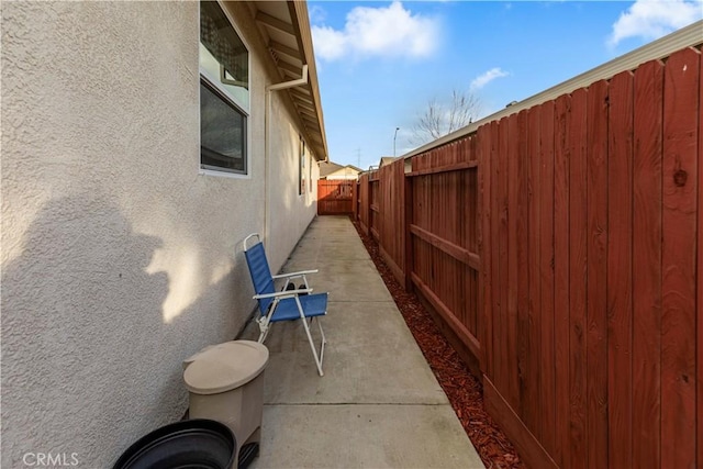 view of home's exterior with fence private yard, a patio area, and stucco siding