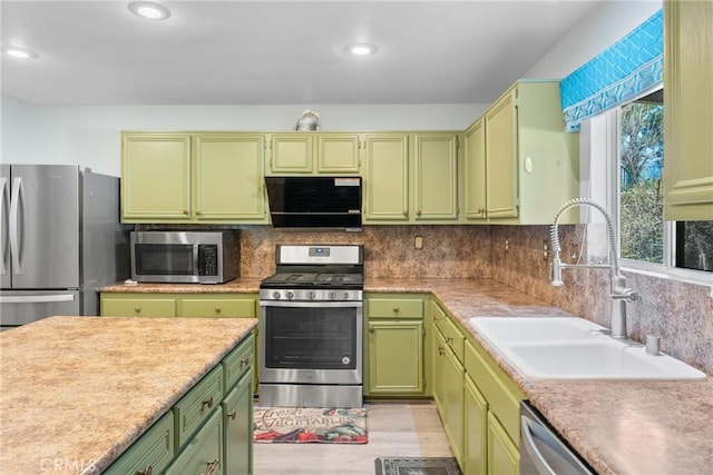 kitchen with stainless steel appliances, light countertops, and a sink