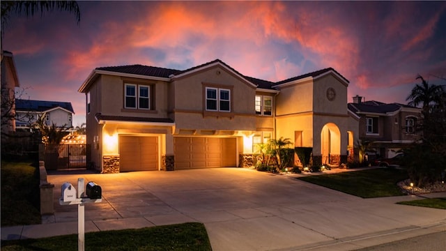 view of front facade with stone siding, concrete driveway, an attached garage, and stucco siding