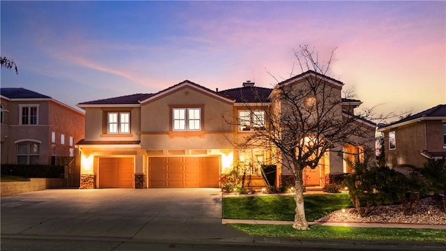 view of front of property with driveway, a chimney, stucco siding, a garage, and a tiled roof