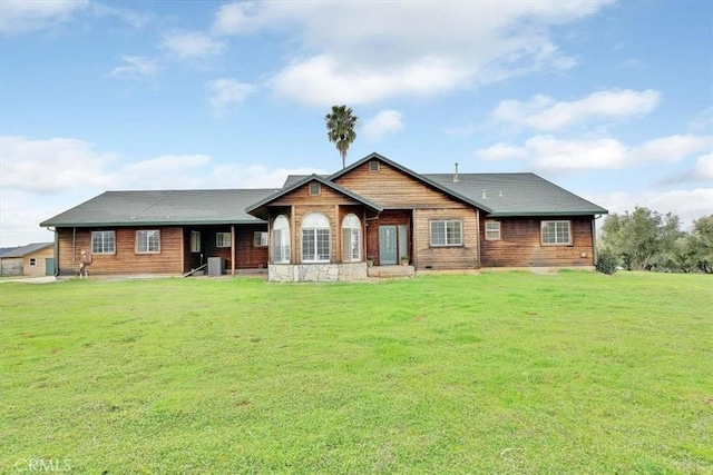 back of house featuring a lawn and central air condition unit