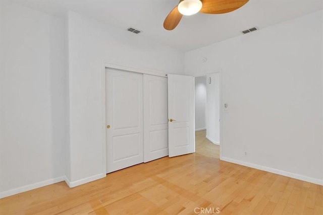 unfurnished bedroom with baseboards, visible vents, and light wood-style floors