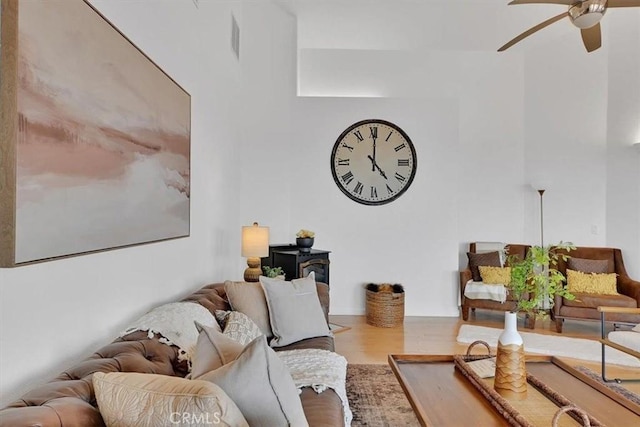living room with a ceiling fan and wood finished floors