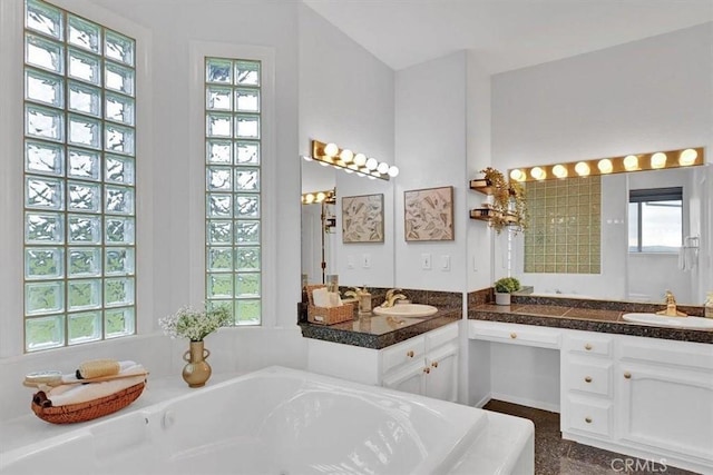 bathroom with vanity and a bath