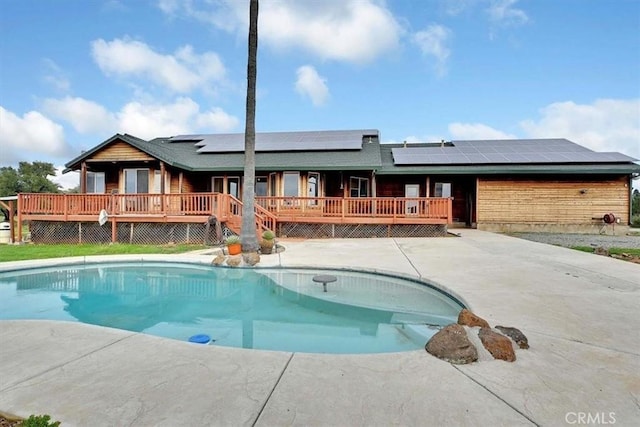 outdoor pool featuring a patio area and a deck