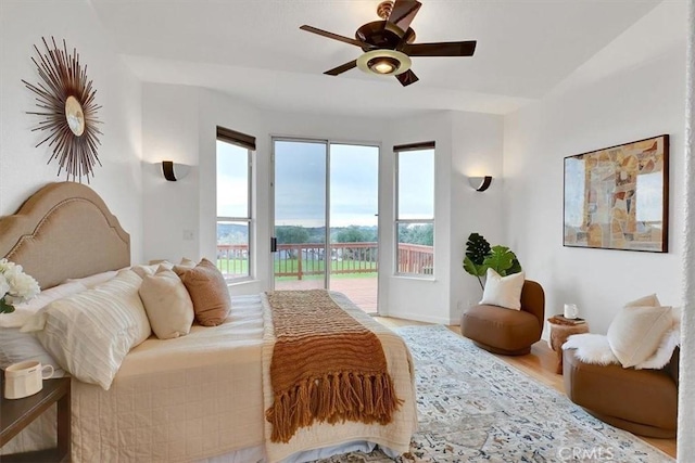 bedroom with baseboards, access to outside, ceiling fan, and wood finished floors