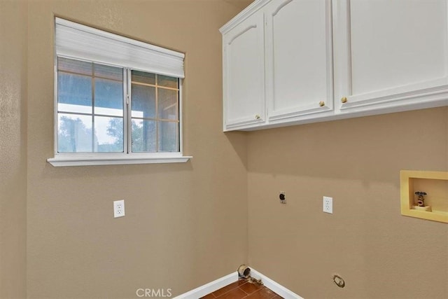 clothes washing area with gas dryer hookup, electric dryer hookup, cabinet space, baseboards, and hookup for a washing machine