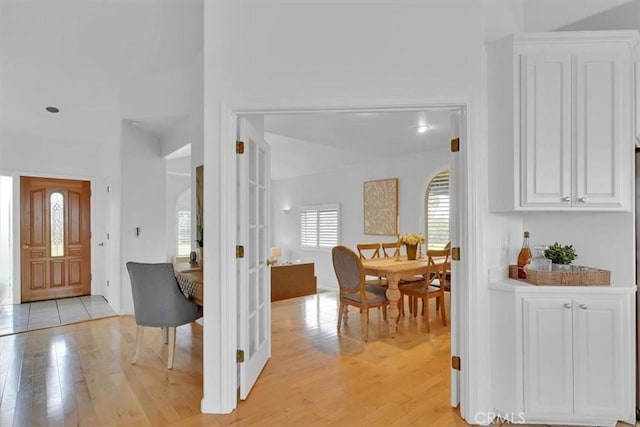 interior space featuring light wood-style floors and arched walkways