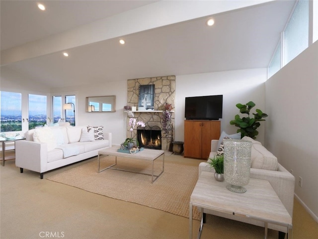 living room featuring a fireplace, light colored carpet, and recessed lighting