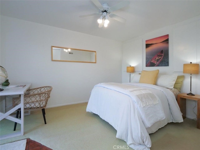 bedroom with a ceiling fan, carpet flooring, and baseboards