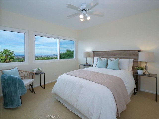 carpeted bedroom with a ceiling fan and baseboards