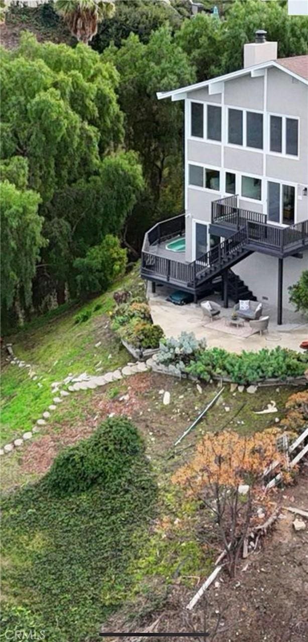 view of yard with a wooden deck and a patio area