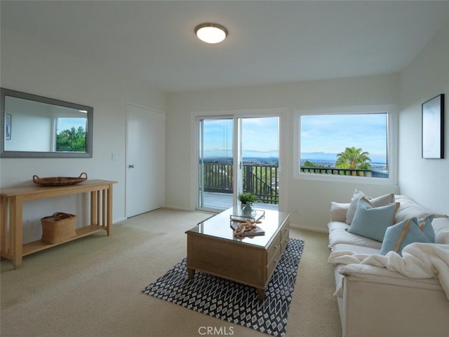 living room featuring light carpet and baseboards