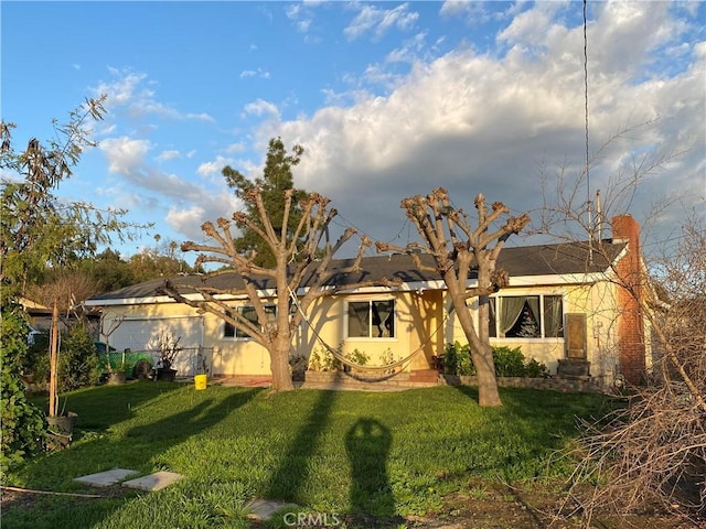 view of front of home with a front lawn and stucco siding