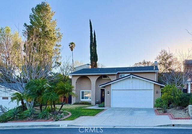 8373 Denise Ln, West Hills, CA 91304 - view of front facade with a garage, stucco siding, concrete driveway, and a front yard
