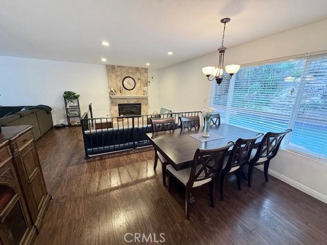 8373 Denise Ln, West Hills, CA 91304 - dining area with healthy amount of natural light, wood finished floors, a fireplace, a chandelier, and recessed lighting