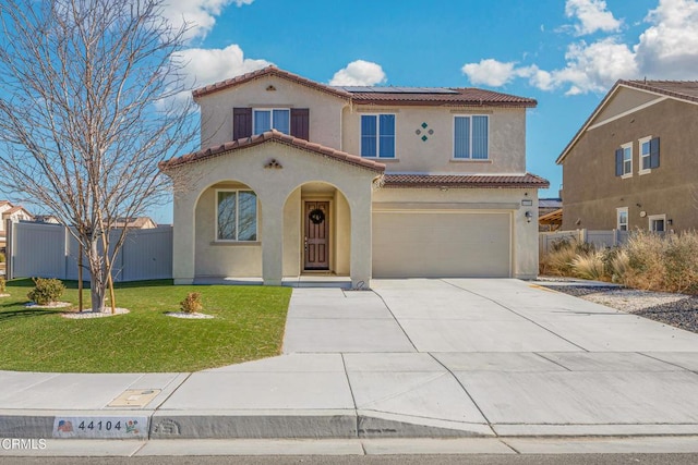 mediterranean / spanish-style house featuring a garage, solar panels, a tile roof, stucco siding, and a front yard