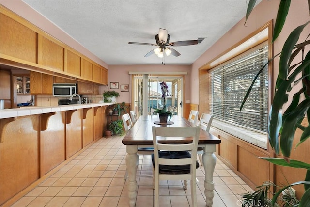 dining space featuring light tile patterned floors, ceiling fan, and visible vents