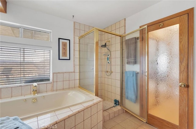 full bathroom with a garden tub, tile patterned flooring, and a shower stall