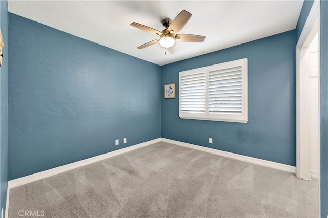 unfurnished room featuring ceiling fan, carpet flooring, and baseboards