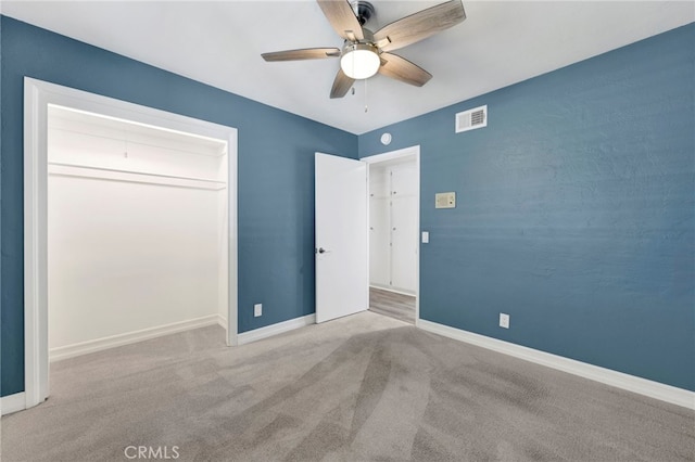 unfurnished bedroom featuring baseboards, visible vents, ceiling fan, and light colored carpet