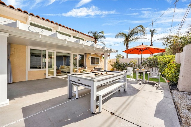 view of patio featuring outdoor dining space and fence