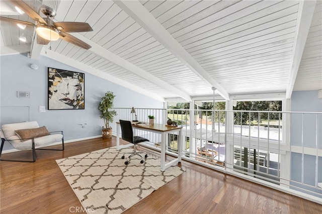 office space with ceiling fan, vaulted ceiling with beams, baseboards, and wood finished floors