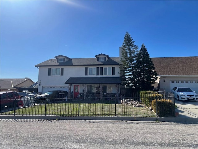 view of front of home featuring a fenced front yard, concrete driveway, a front yard, stucco siding, and an attached garage