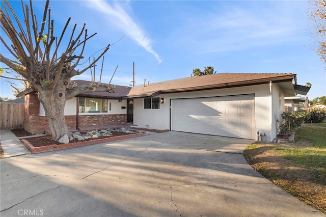 ranch-style house with an attached garage, brick siding, fence, driveway, and stucco siding