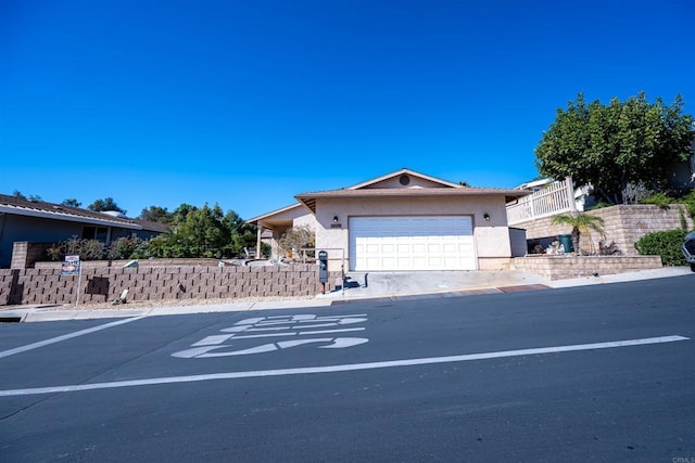 ranch-style house with an attached garage and stucco siding