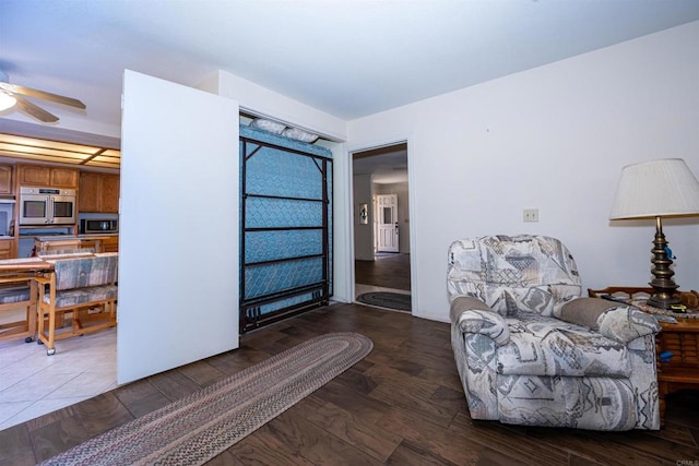 sitting room with wood finished floors and ceiling fan