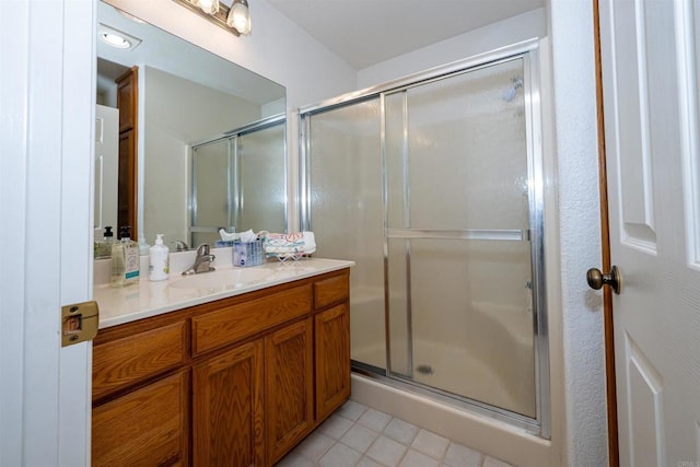 bathroom featuring tile patterned floors, a stall shower, and vanity