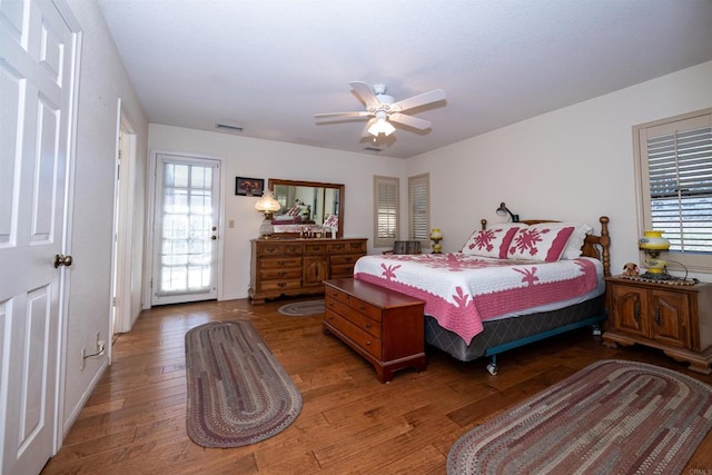 bedroom featuring visible vents, ceiling fan, and wood finished floors
